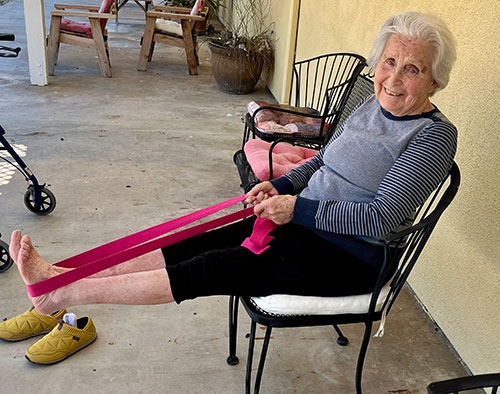 Senior woman doing chair yoga